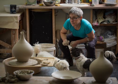 Mary Fox checking her work off the wheel Sasha and amy